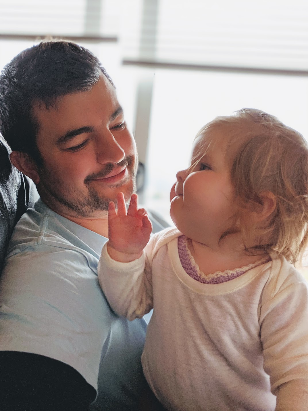 Denis looking at Mia as a baby